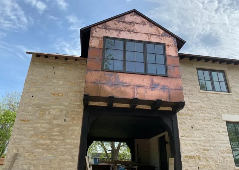 Copper metal panel facade on a stone building for Skylight Installation in Ashwaubenon