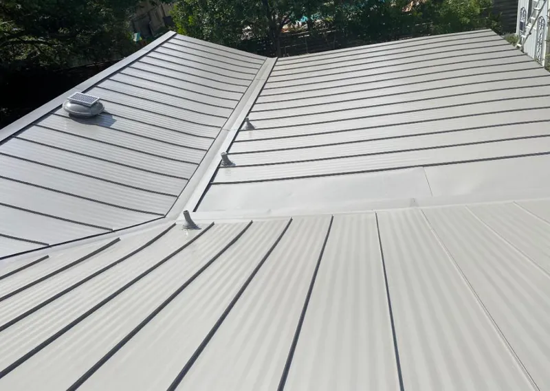 Solar attic fan installed on a metal roof for Roof Ventilation in Ashwaubenon
